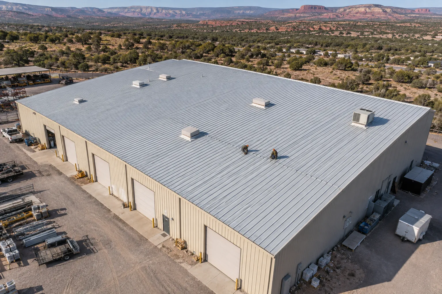 Metal warehouse roof with turbine vents seen from above