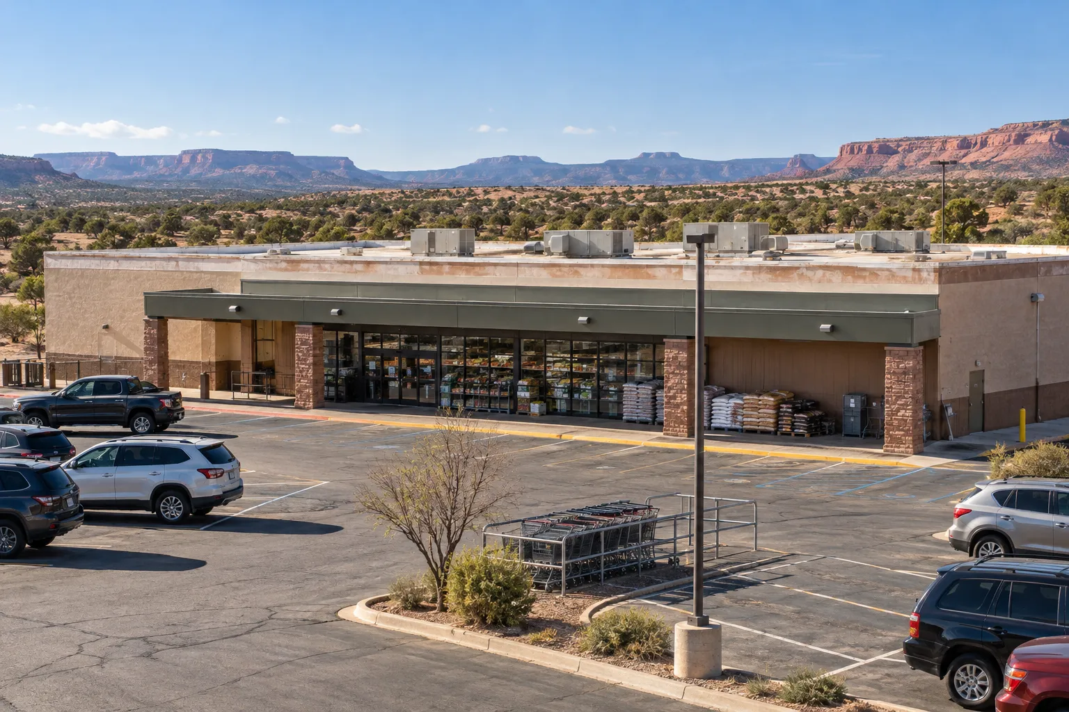 Single-story retail strip with a flat roof and rooftop units seen from the parking lot in Camp Verde, AZ